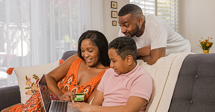 Young couple with their son looking at the laptop photo